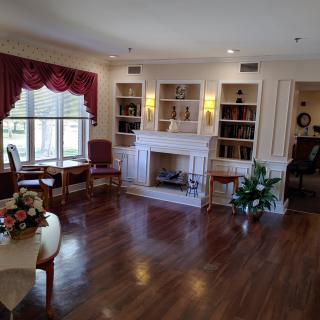 A cozy living room with a fireplace, bookshelves, and elegant decor.