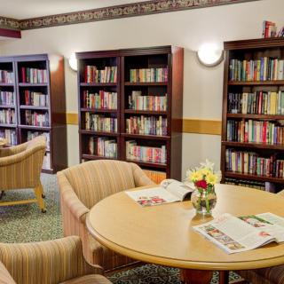 A cozy library reading area with bookshelves and comfortable seating.