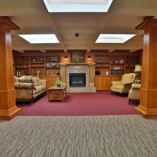 Cozy library interior with a fireplace and comfortable seating.