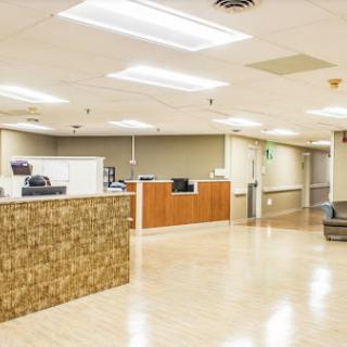 A spacious and modern reception area in a healthcare facility, featuring a welcoming design and ample seating.