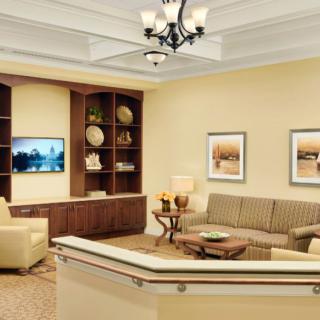 A cozy living room with a sofa, coffee table, TV, and decorative elements.
