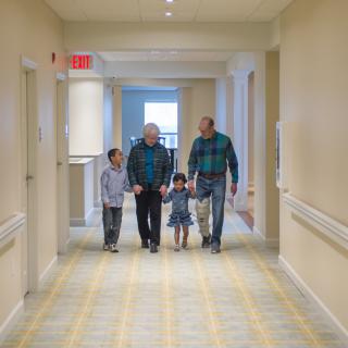 A family walking together down a hallway.