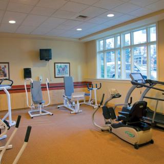 A well-equipped gym with various exercise machines and fitness equipment.