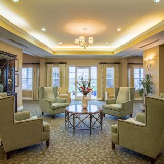 Elegant living room with plush seating and large windows.
