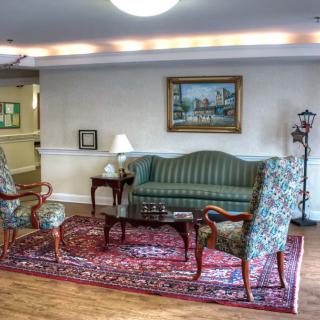 A cozy living room with classic furniture and artwork.