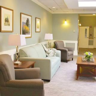 A cozy living room with comfortable seating, soft lighting, and tasteful artwork.