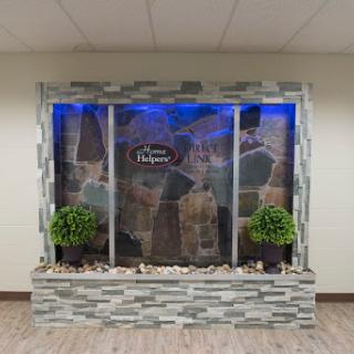 A stylish indoor water feature with stone accents and LED lighting, enhancing the ambiance of the space.