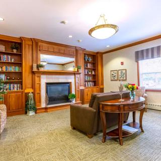 A cozy living room with a fireplace and comfortable seating.