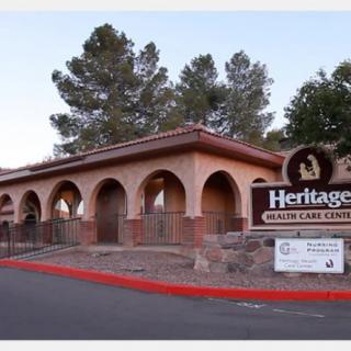 A view of a healthcare facility with prominent signage and surrounding trees.