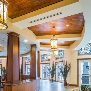 A modern hotel lobby with wooden accents and warm lighting.