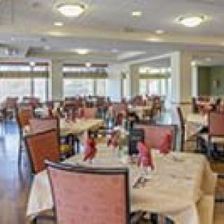 A spacious and elegantly arranged dining area with neatly set tables.