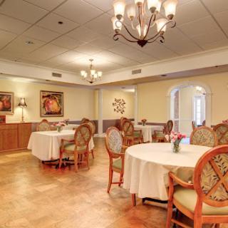 A beautifully designed dining room featuring elegant tables and chandeliers.