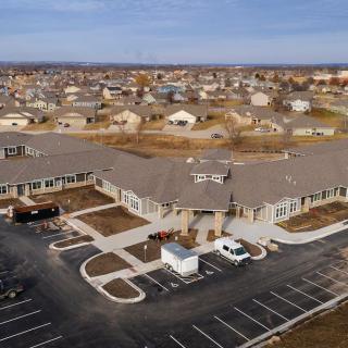 Aerial view of a suburban building with surrounding residential area.