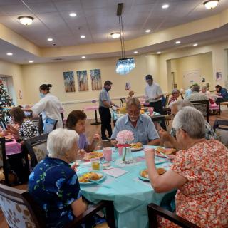 Residents enjoying a meal together in a communal dining area.