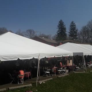 Tents set up for an outdoor event under a clear blue sky.