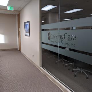A modern office space featuring a glass wall with signage.