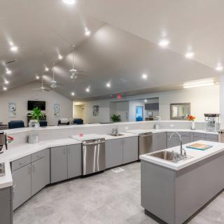 A spacious and modern kitchen with sleek countertops and bright lighting.