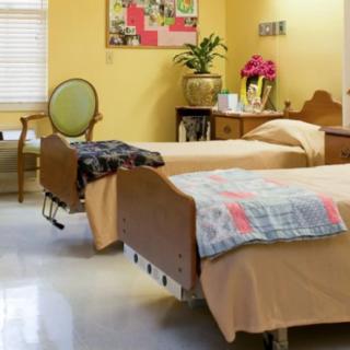 A hospital room with two beds and a variety of decor, creating a welcoming environment.