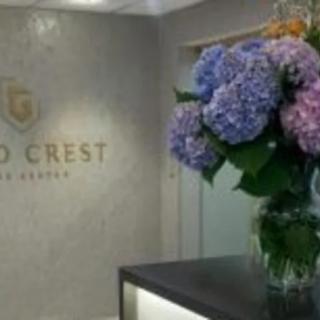 A well-decorated office reception area with a vase of colorful hydrangeas.