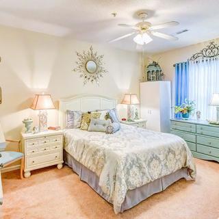 A cozy and traditionally styled bedroom with elegant decor and soft lighting.