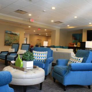 A modern lobby with comfortable blue seating and stylish decor.