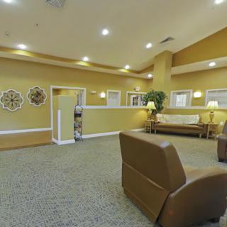 A spacious and well-lit lobby featuring comfortable seating and decorative elements.
