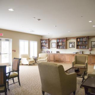 A cozy lounge area with comfortable seating and bookshelves.