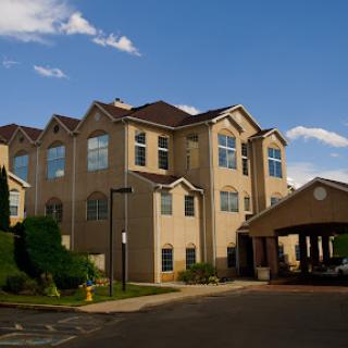A beautifully designed hotel with a welcoming entrance under a clear blue sky.