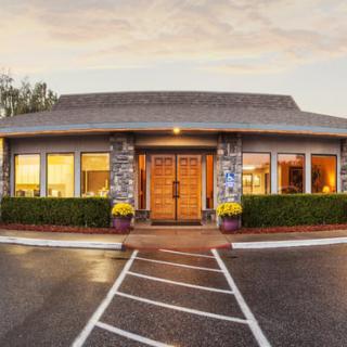 A cozy restaurant exterior with a welcoming entrance and well-lit windows.