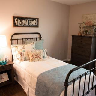 Cozy bedroom with vintage-style decor and a comfortable bed.