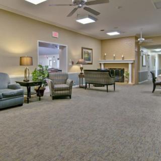 A cozy lounge area with sofas, chairs, and a fireplace.