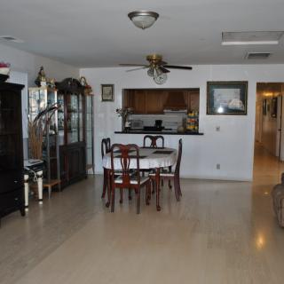 A spacious dining area with a wooden table set and decorative home furnishings.