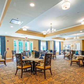 A spacious and well-lit dining area with elegant decor and comfortable seating.