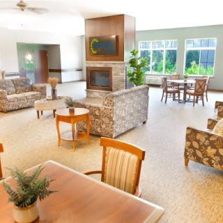 A spacious and modern lounge area with comfortable seating and large windows.