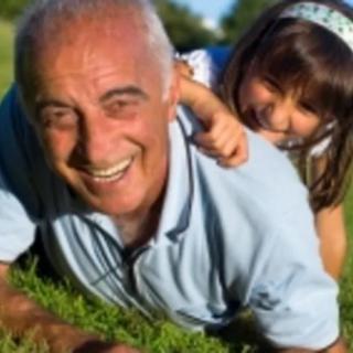 A joyful grandparent and child playing together outdoors.