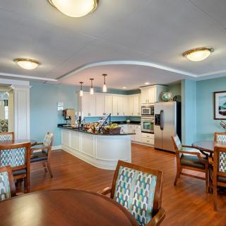 A modern kitchen and dining area with elegant furnishings and wood flooring.