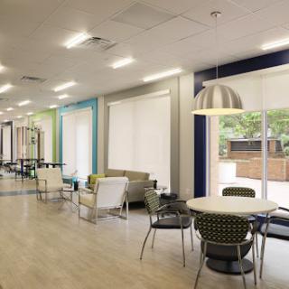 A modern lounge area featuring comfortable seating and plenty of natural light.