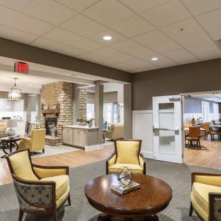 A cozy and modern lobby area featuring comfortable chairs and a central table.