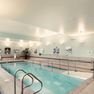 A tranquil indoor swimming pool with modern interior design, perfect for exercise and relaxation.