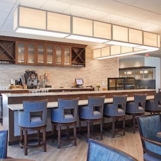 A modern bar with blue seating and elegant lighting.