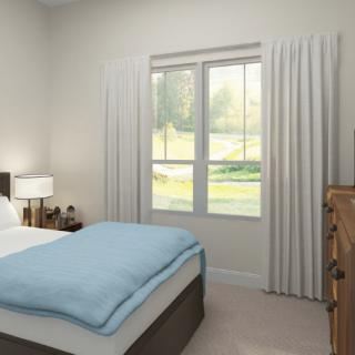 A minimalist bedroom with a neatly made bed, large window, and simple furnishings.