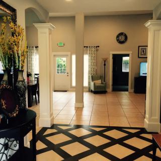 A welcoming lobby with elegant columns and decorative floor tiles.