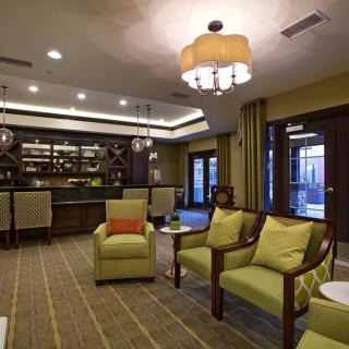 A stylish and cozy lounge with comfortable seating, elegant lighting, and a bar area.