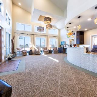 A spacious and well-lit lobby with modern design elements and large windows.
