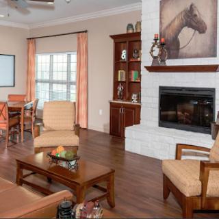 Modern and cozy living room with a warm atmosphere, featuring elegant furniture and a fireplace.