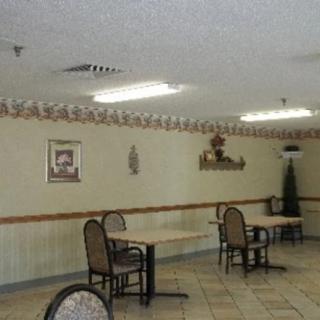 An empty dining area with several tables and chairs.