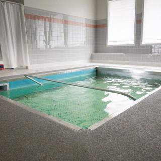 An indoor therapy pool designed for rehabilitation and water exercises.
