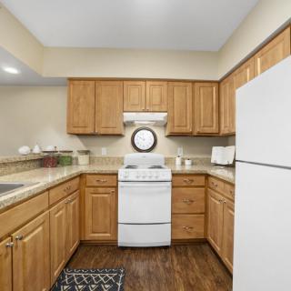 A cozy kitchen with wooden cabinets and modern appliances.