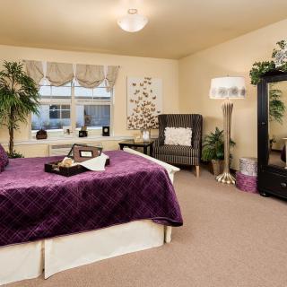 A cozy modern bedroom with elegant decor and indoor plants.