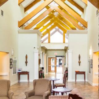 A spacious living room with a vaulted ceiling and modern furnishings.